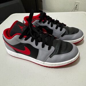 Jordan 1 Low GS (Grade School) in the "Cement Grey, Fire Red"